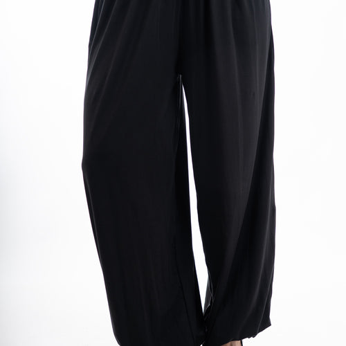modella indossando Pantalone balloon in viscosa elasticizzata con fondo arricciato colore Nero Unica