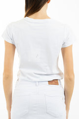 modella indossando T-shirt in cotone elasticizzato con applicazioni floreali e piume colore