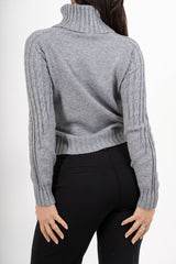 modella indossando Dolcevita CozyCable spalle treccia colore