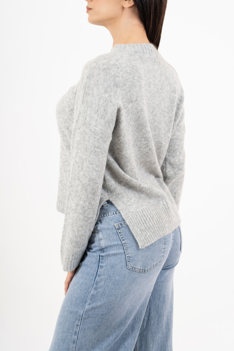 modella indossando Maglione over girocollo con fondo asimmetrico e spacchi laterali colore