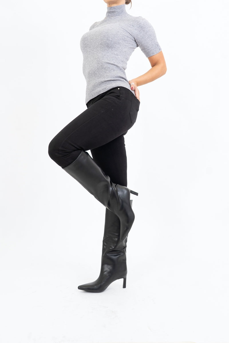 modella indossando Stivali alti in ecopelle nera con tacco 6cm e punta affusolata colore