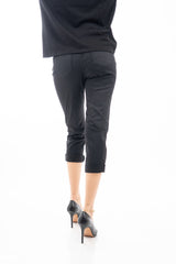 modella indossando Pantalone modello chinos in cotone elasticizzato colore nero con bottoni gioiello a cuore colore