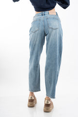 modella indossando Jeans balloon in denim elasticizzato con fondo taglio vivo colore