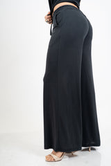 Pantalone palazzo in viscosa elasticizzata con coulisse Made in Italy.