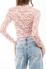modella indossando Maglia in pizzo elasticizzato trasparente a fiori manica lunga colore
