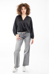 modella indossando Blusa in raso fluido con scollatura incrociata e maniche a palloncino colore