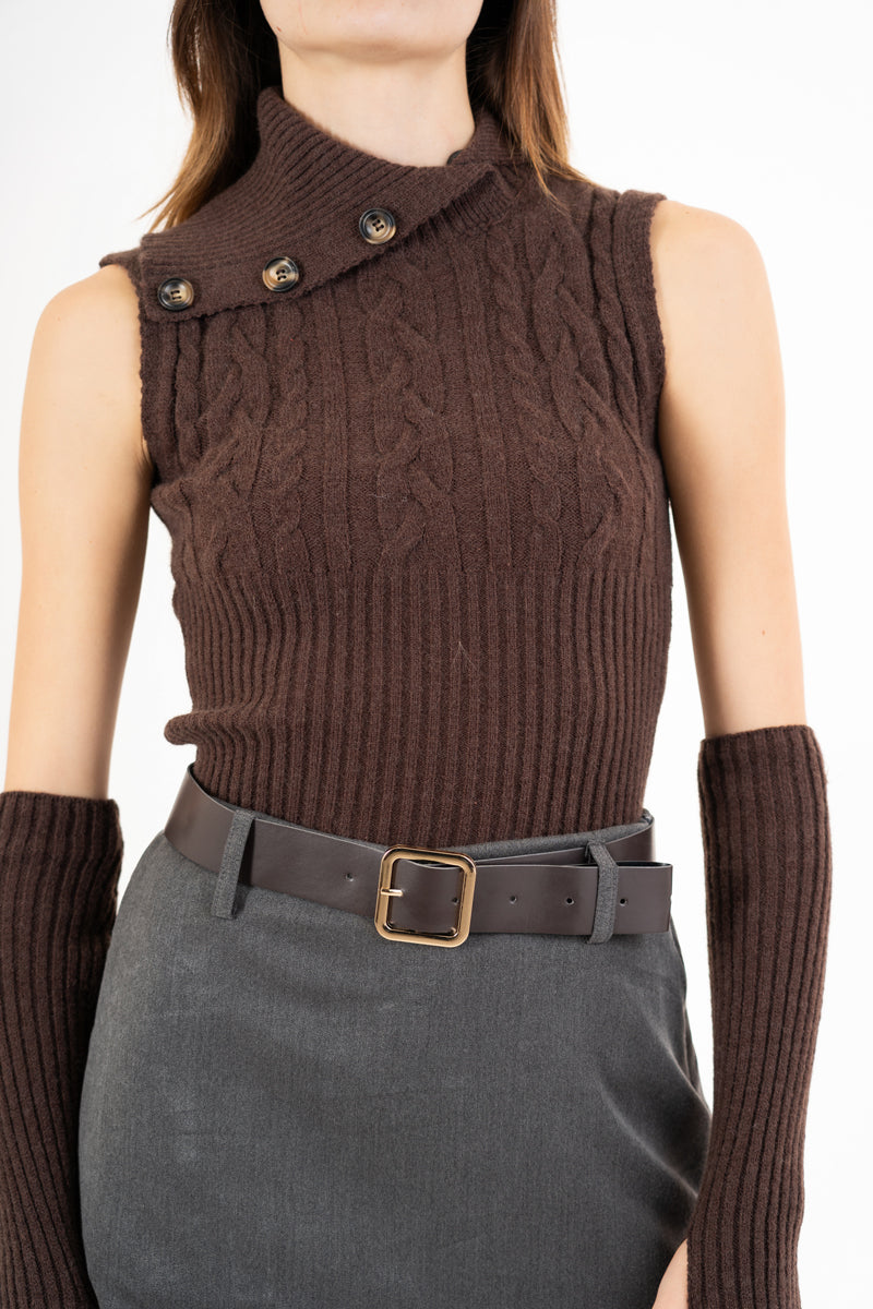 modella indossando Maglia smanicata a trecce con collo alto e bottoni laterali colore Marrone Unica