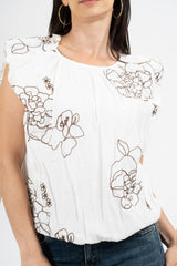 Blusa ricamata in tencel con spalle ad aletta e fondo balloon.