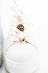 modella indossando Sneakers platform bianche con charm gioiello – dettaglio oro colore