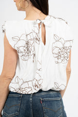 Blusa ricamata in tencel con spalle ad aletta e fondo balloon.