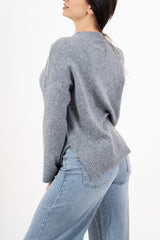 modella indossando Maglione over girocollo con fondo asimmetrico e spacchi laterali colore