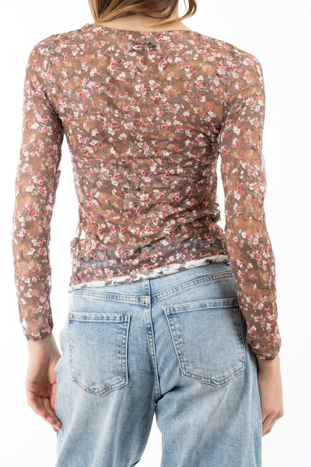 modella indossando Maglia in pizzo elasticizzato trasparente a fiori manica lunga colore