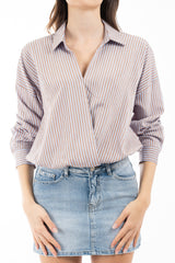 modella indossando Blusa rigata in viscosa con scollo incrociato e fondo elasticizzato colore Celeste Unica