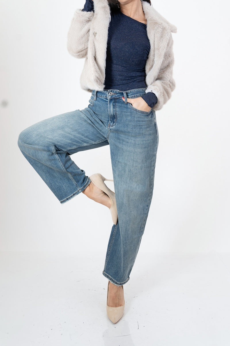 modella indossando Jeans mom fit a vita alta con fondo sfrangiato colore
