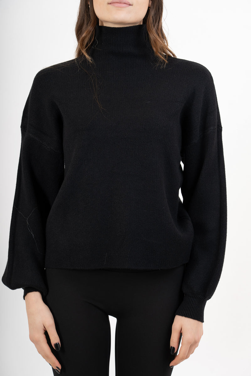 modella indossando Maglia over in filato spesso con collo vulcano e maniche a palloncino colore Nero Unica