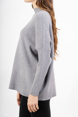 modella indossando Maglia over corta in filato caldo con maniche a costine e collo alto colore