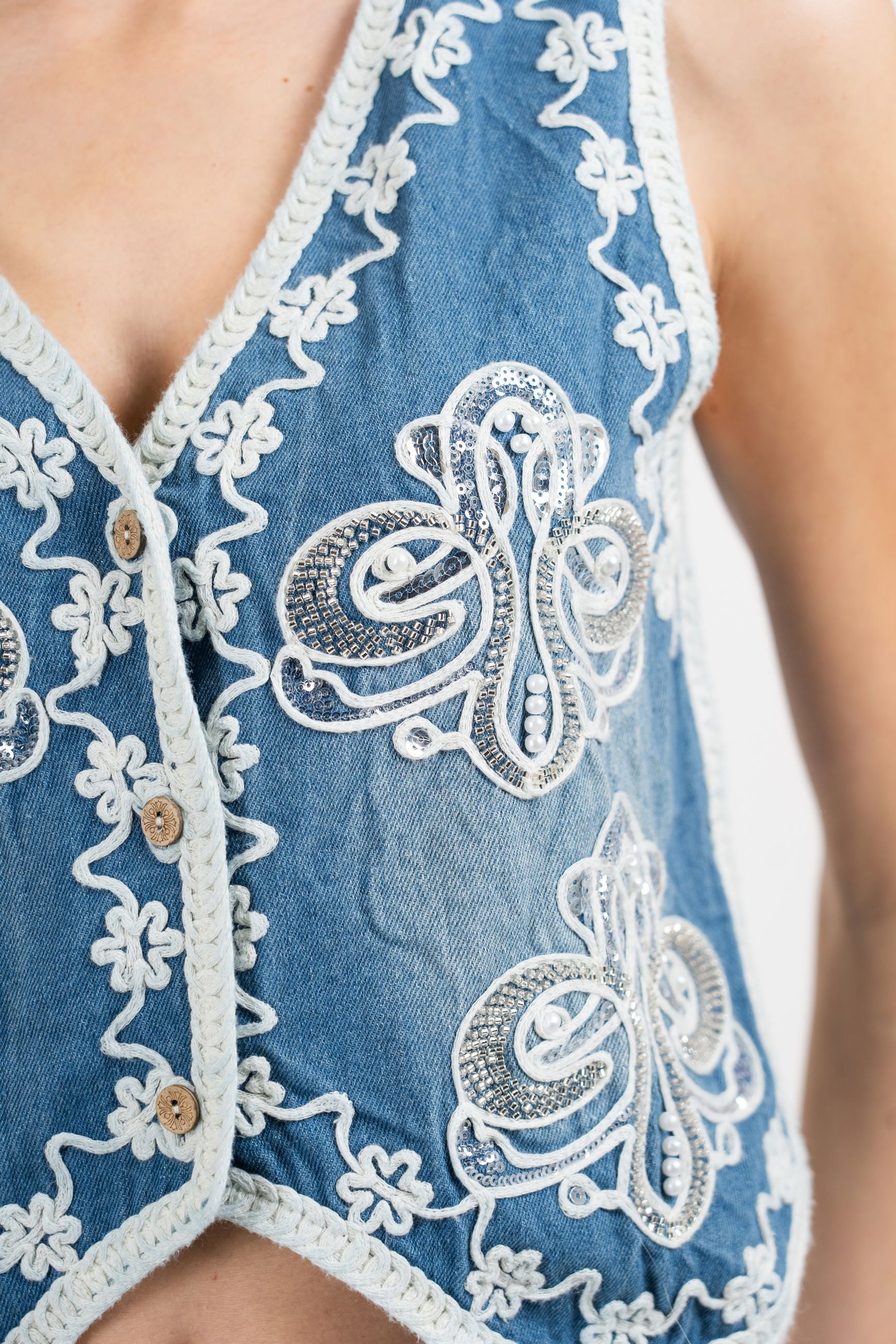 Gilet denim ricamato con perle e paillettes.